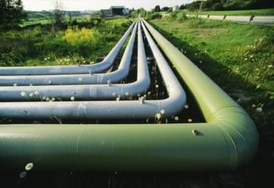Pipelines running through green grassy field.
